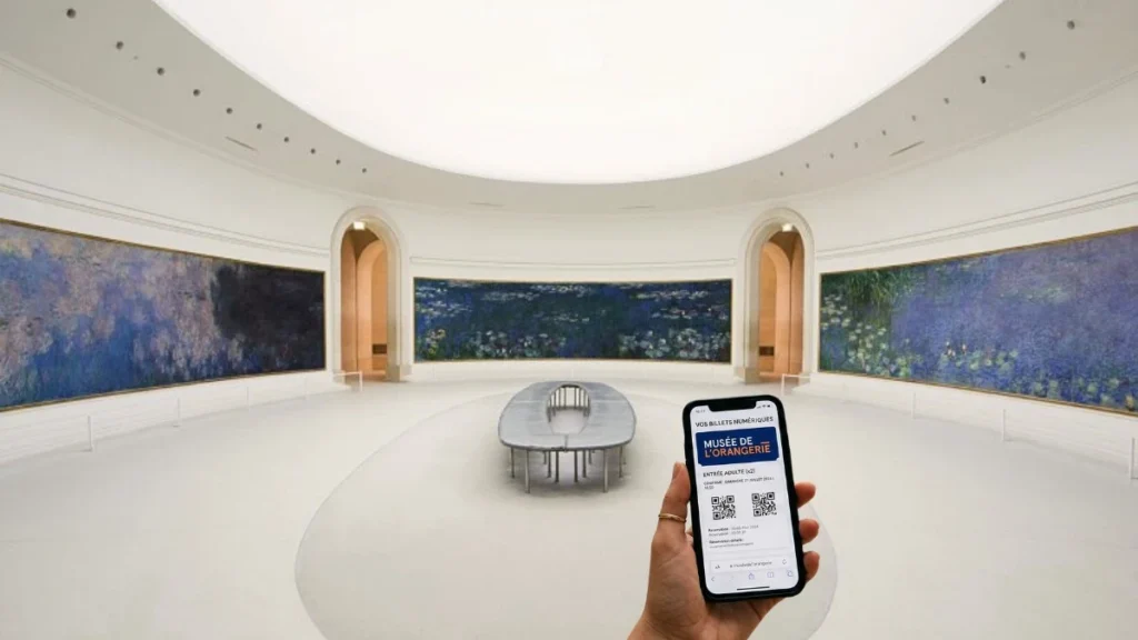 Hand holding a smartphone displaying a digital ticket to the Musee de l'Orangerie, with Claude Monet's monumental Water Lilies in the background inside the bright oval room.