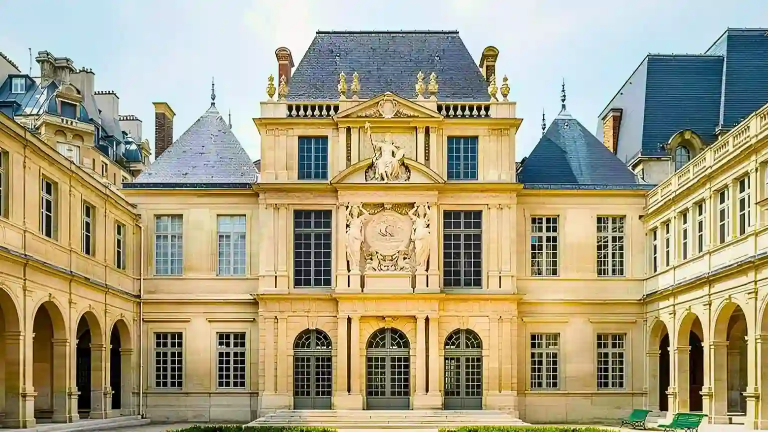 The stunning Renaissance architecture of the Carnavalet Museum's inner courtyard in Paris, featuring magnificent stone facades, elegant arches, and a beautifully peaceful atmosphere.